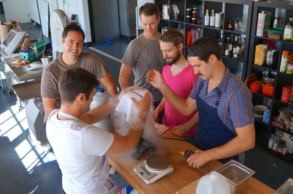Chris Young, far left, and Grant Crilly, far right, with other members of the ChefSteps team in the startup's Pike Place Market space. (GeekWire File Photo.)