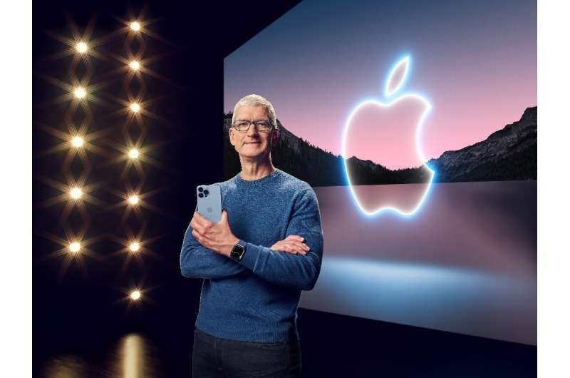 This handout image obtained September 14, 2021 courtesy of Apple Inc. shows Apple CEO Tim Cook with the iPhone 13 Pro Max and Ap